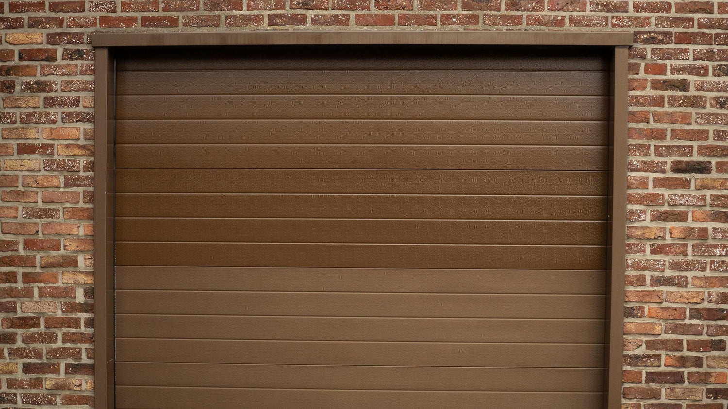 Restored aluminium garage door on a brick facade
