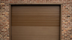 Restored aluminium garage door on a brick facade