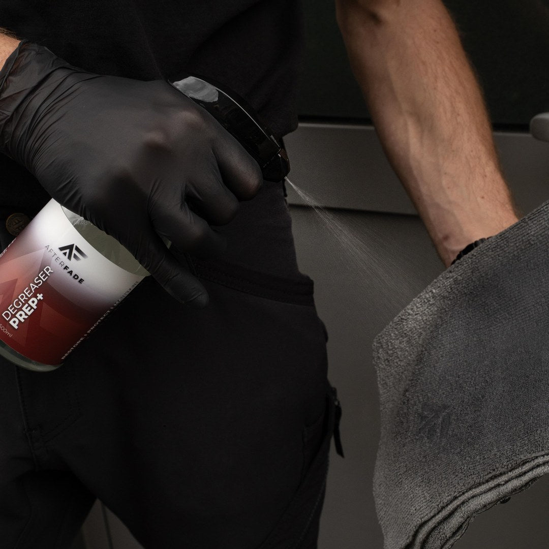 Spraying Afterfade Degreaser Prep+ to clean the surface