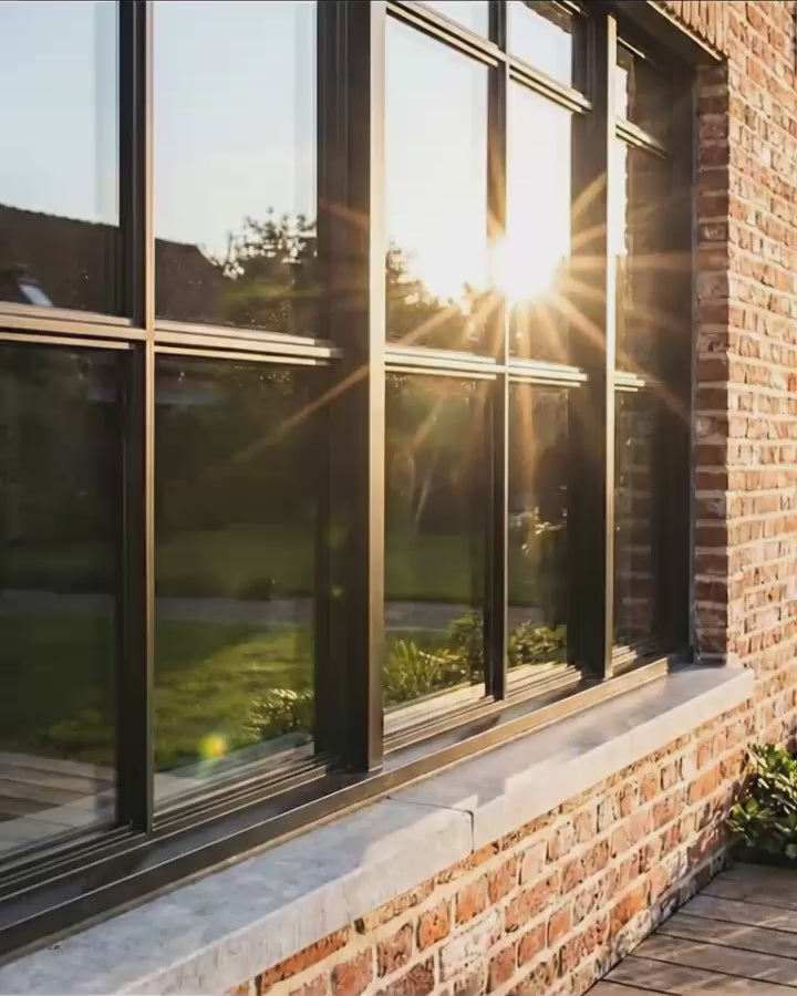 Restored black window frames at sunset